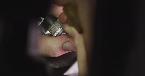 Close up of the hands of a goldsmith while he is working on a diamond ring. Concept: Style, fashio