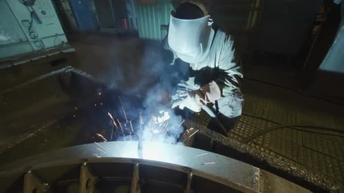 Welding in Action A Skilled Worker is Expertly Fabricating Intricate Metal Structures Stock Clip