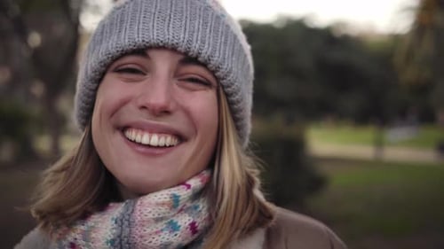 Smiling Woman in Hat and Scarf in Park