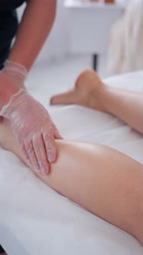 Therapist Performing Foot Massage in Gloves in Spa Center Concept of Cosmetic Body Treatments for