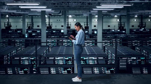 Side View Of Full Body Asian Business Woman Using Tablet In Data Center