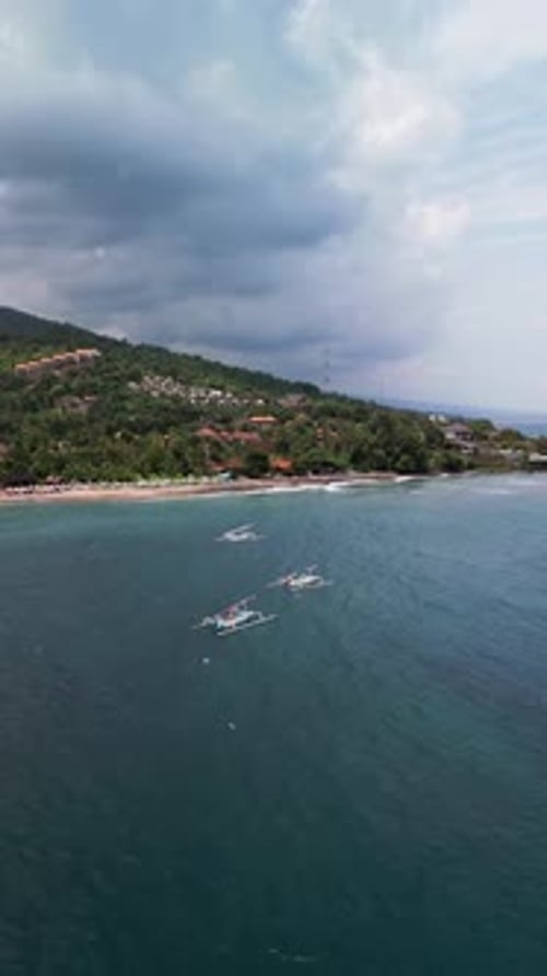 Vertical Aerial Footage of Calm Tropical Bay with Fishing Boats and Coastal Village in Amed