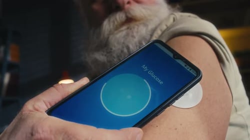 Adult Checking Glucose Level with Smartphone