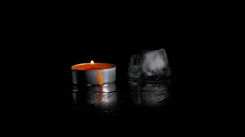 One Melting Ice Cube on Black Background