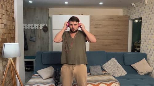 Man Dancing and Listening to Music in Living Room