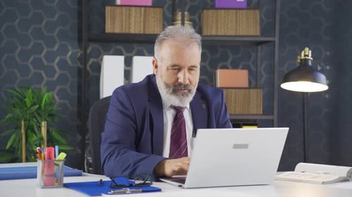 Man Working on Laptop in Modern Office