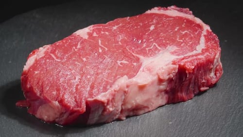 Steak Meat Rotating Background. Raw Beef Ribeye Close Up Video Backdrop. Food Concept