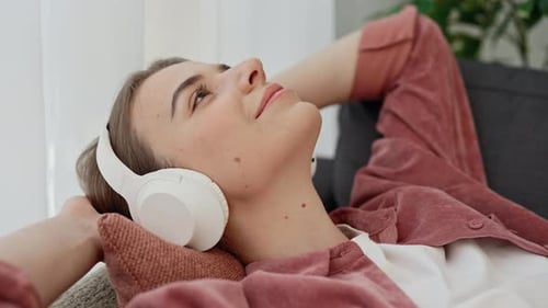 Side View of the Beautiful Caucasian Woman is Resting After Studying Closes Her Eyes Lying on the