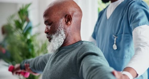 Senior Adult Exercising With Pink Dumbbells at Home