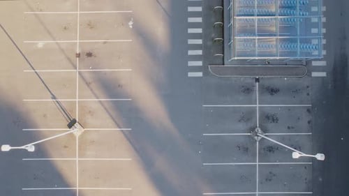 Aerial View Of Empty Parking Lot During COVID-19 Pandemic Lockdown At Daytime.