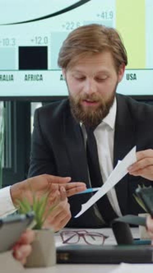 Business Discussion with Charts in the Background