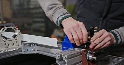 Crop Mechanic Assembling Mechanism in Workshop Unrecognizable Male Worker Tightening Screws While