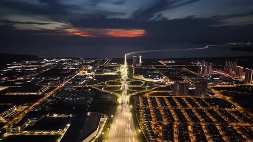 Aerial Batu Kawan town at night with a large building in the middle