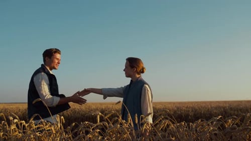Farmers Meet and Shake Hands in a Wheat Field