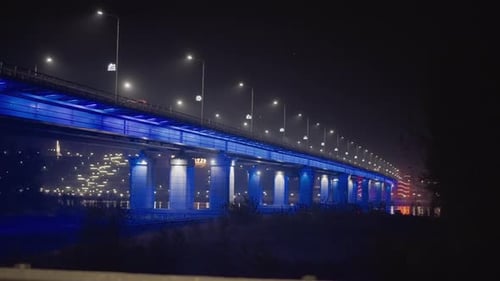 Serene River Scene with Illuminated Bridge and City Lights Peaceful Nocturnal Scene Showcasing
