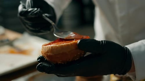 Chef Adds Sauce to Burger Bun Close-Up