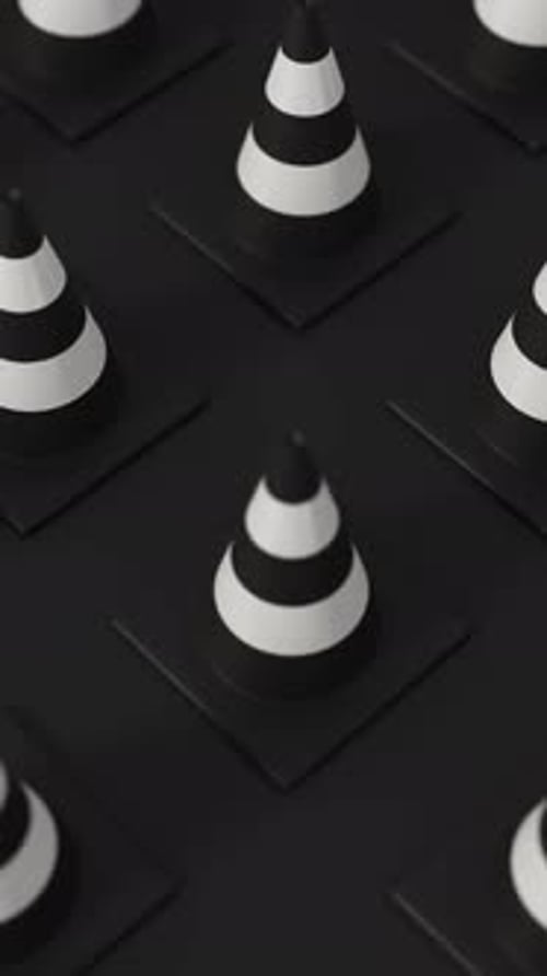 High Angle Grid of Traffic Cones in White and Black on a Black Background for Road Safety and