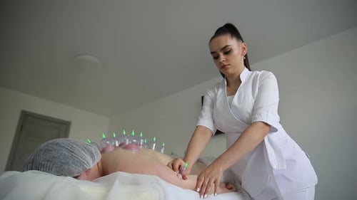 Woman Receives Cupping Treatment from Health Professional