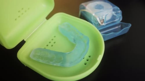 Close Up of a Mouth Guard and Floss