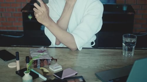 Person Applying Cream to Face in Mirror