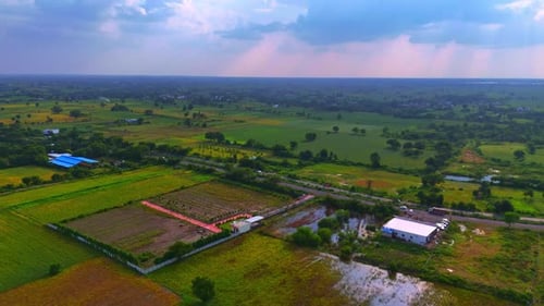 Aerial View of Verdant Fields and Countryside Road
