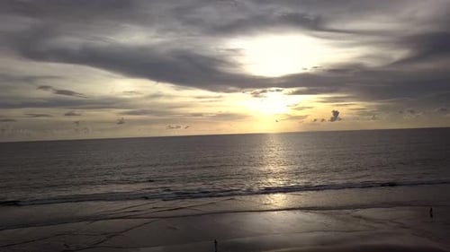 Aerial view of Golden Sunset on sea. AERIAL BACKWARD DESCENDING SHOT on sunrise reflected on water.