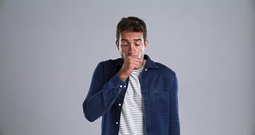 Face, sick and man with a cough, allergy and lung disease with bacteria on a grey studio background