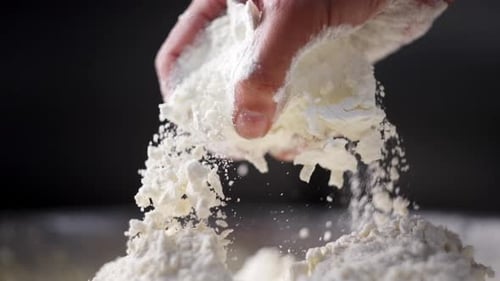 Beautiful view of a hand mixing dough and flour in a fancy kitchen