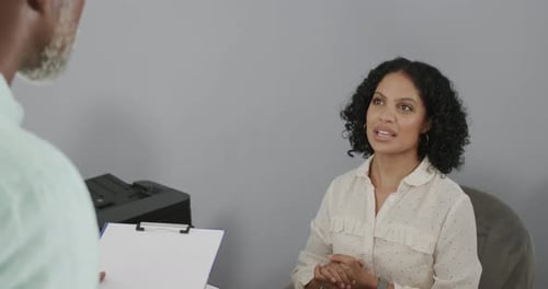 Woman Talking with Coworker in a Bright Office