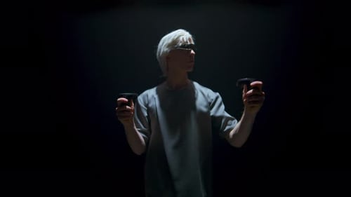 Man Using Virtual Reality Headset and Controllers