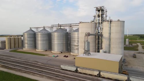 Grain elevator and new modern silos, aerial ascend view