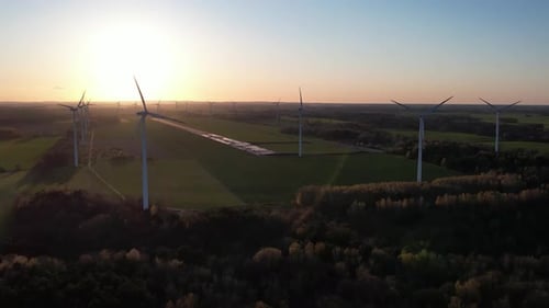 wind turbine farm at sunset, green energy, future electricity, aerial footage.