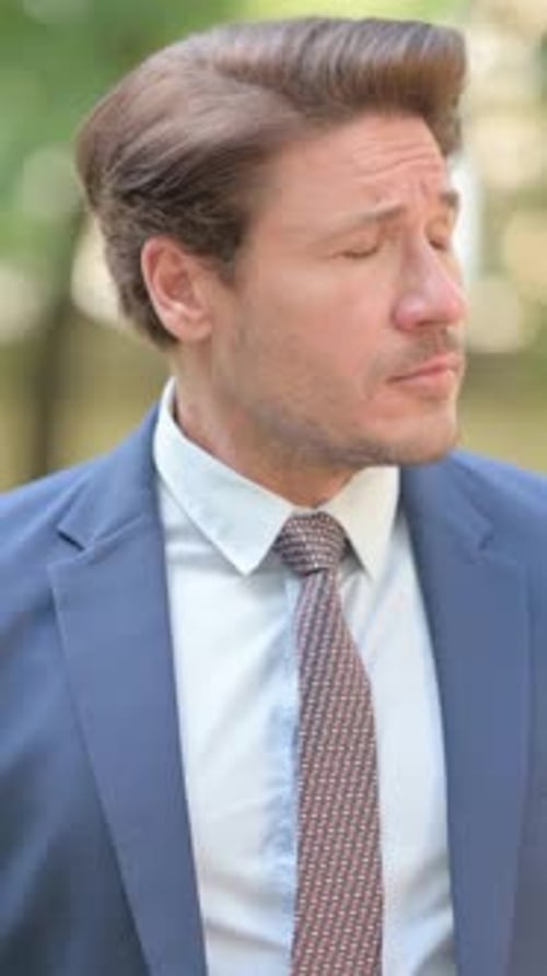 Focused Man in Suit Checking the Time