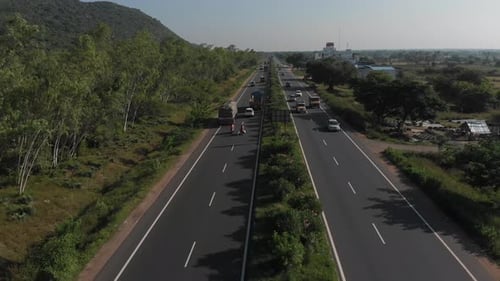 Flying up the middle lane of highway in rural area of India