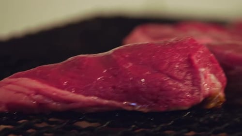 Sizzling Beef Perfection: Close-Up of a Juicy Steak Grilling to Flavorful Excellence