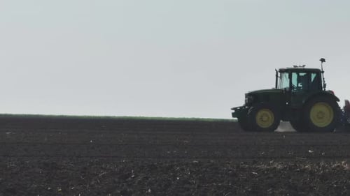 Tractor preparing field for planting