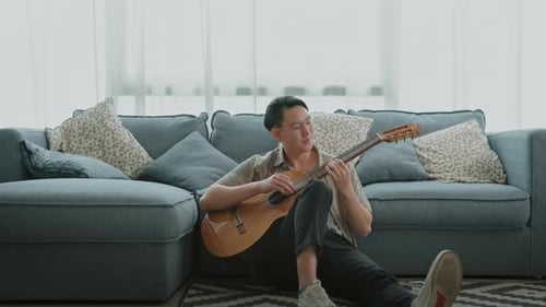 A musician is writing song in home Studio