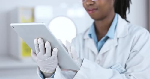 Woman in Lab Coat Using Tablet in Hospital
