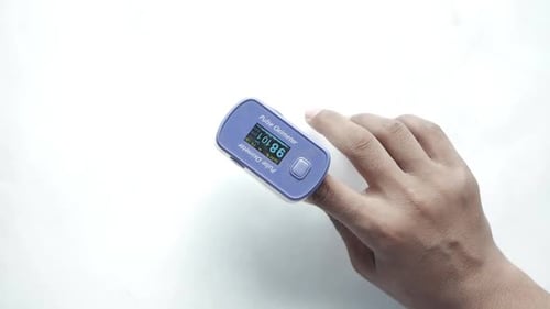 Close Up of Man Hand Using Pulse Oximeter