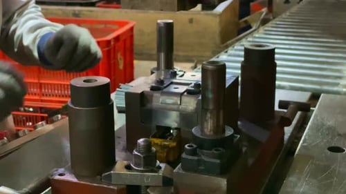 Working press machine, Small parts are inserted into the machine. Close up of worker hands