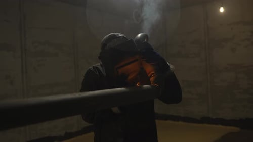 Welder Working on Metal Pipe Indoors