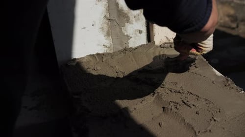 Construction Worker Smoothing Cement with Trowel
