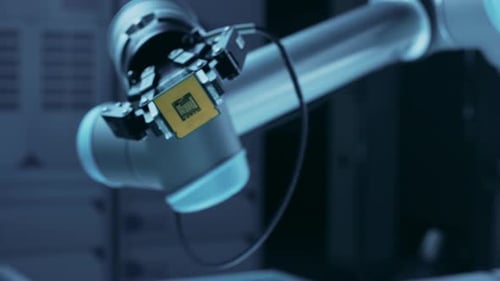 Robotic Arm Holding a Computer Chip Close Up