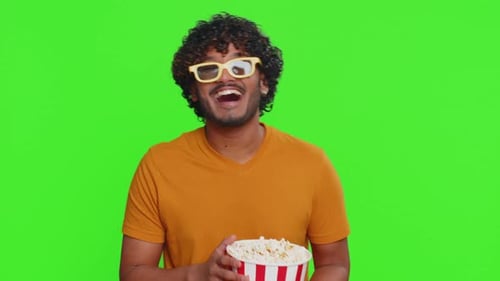Man Laughing While Holding Popcorn Wearing 3D Glasses