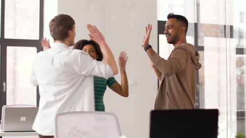 Team High Five in Bright Office Space
