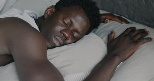 Man Sleeping Peacefully in Bed at Home