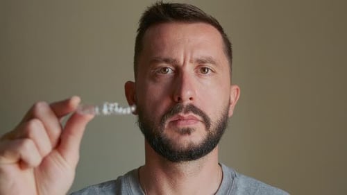 Man Showing Dental Aligner