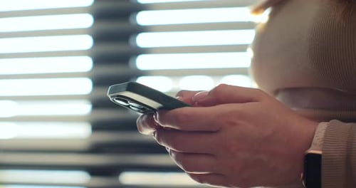 Hand of Woman Using Texting Mobile Phone or Chat Close Up of Woman Hand Sunlight