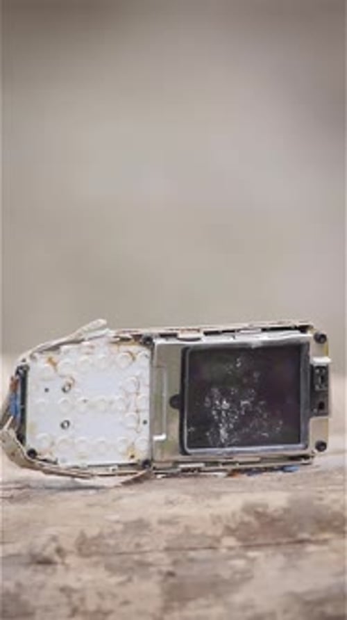 Damaged Retro Mobile Phone Remains Broken Vintage Button Cell Phone Pounded Smashed with