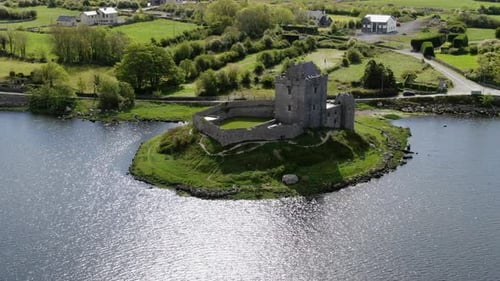 fantastic aerial shot in orbit over the medieval castle of Dunguaire and the waters that surround it